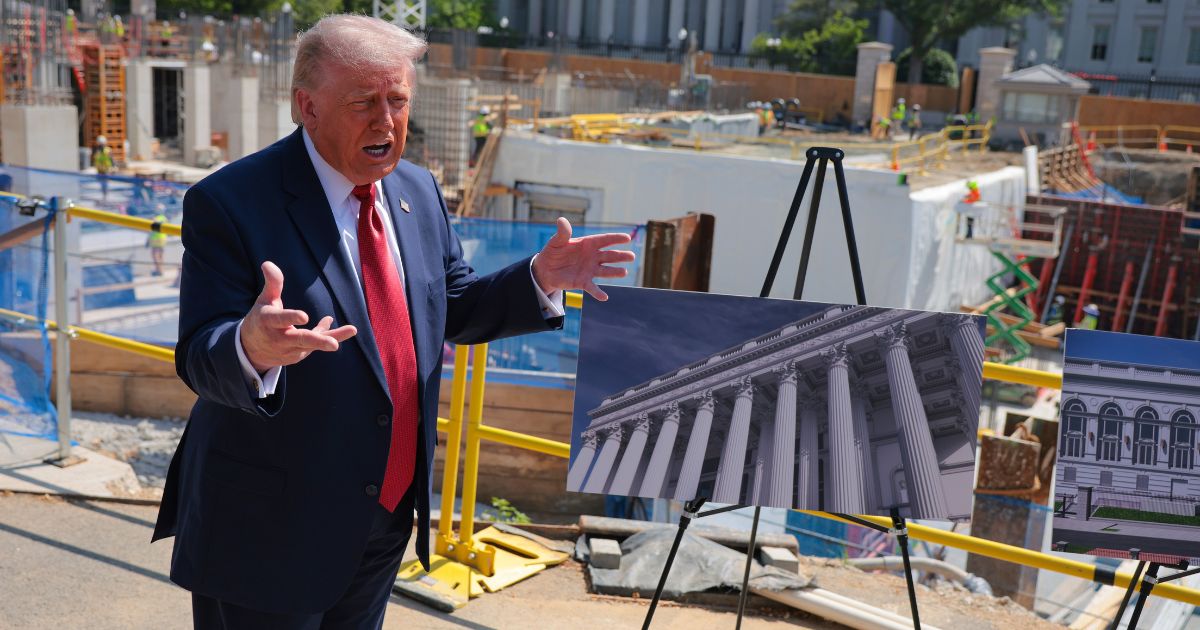 President Donald Trump speaks to the media Tuesday alongside posters of his proposed White House ballroom amid construction at the White House in Washington, D.C.