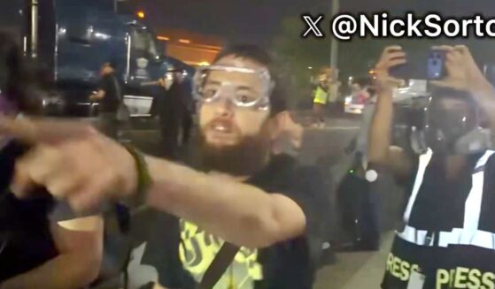 A foul-mouthed protester screams death threats against a law officer's family in video posted to social media Thursday.
