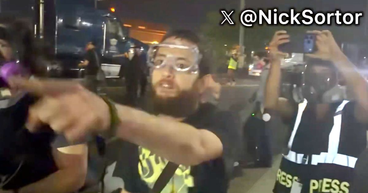 A foul-mouthed protester screams death threats against a law officer's family in video posted to social media Thursday.