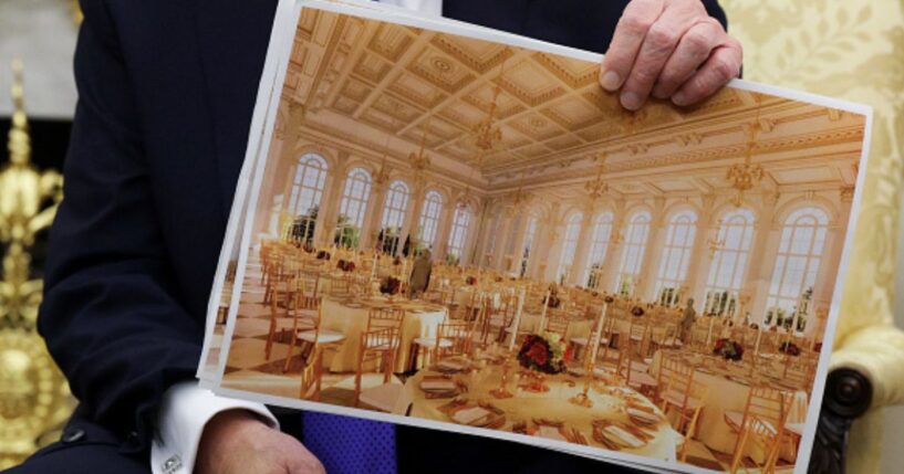 President Trump sits in the Oval Office and shows plans for the White House ballroom on October 22, 2025.