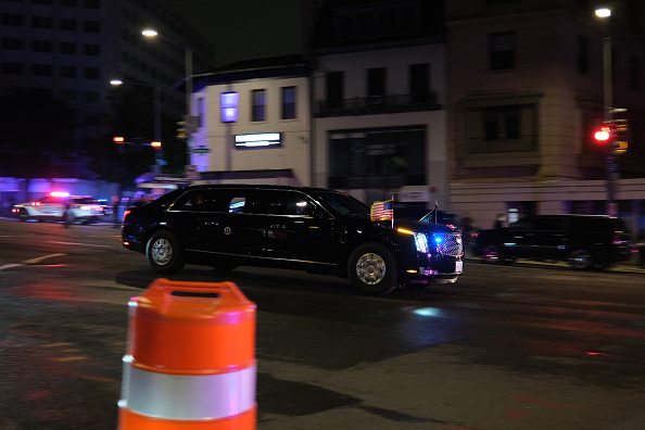 A vehicle of a motorcade flees into the night after the White House Press Correspondents’ Dinner incident.