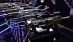 Rows of rifles sit at a gun expo on May 8, 2026.