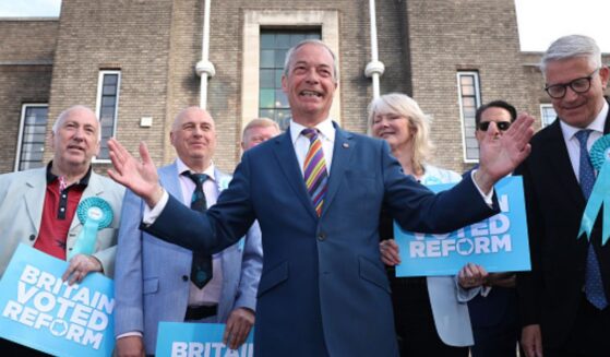 Nigel Farage stands outside a council building celebrating Reform UK's historic local election victory on May 8, 2026.