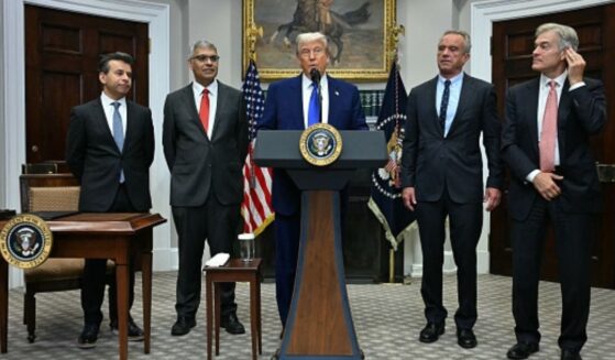 President Trump stands with administration officials such as Secretary of HHS Kennedy, FDA Commissioner Makary, and others on May 12, 2026.