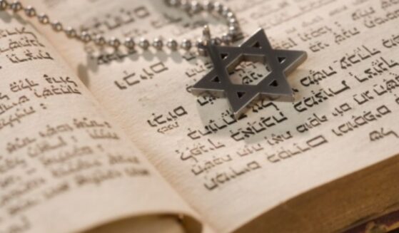 A Star of David medallion sits on a Torah.