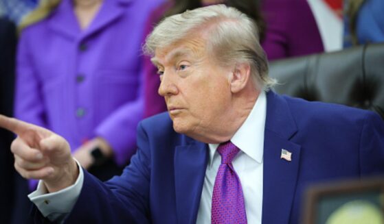 President Donald Trump sits in the Oval Office during his maternal healthcare announcement on May 11, 2026.