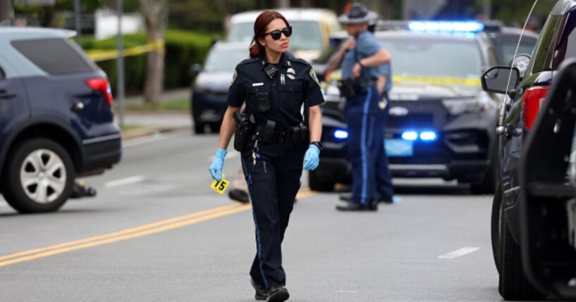 An officer walks on the scene of the Cambridge, Massachusetts incident.