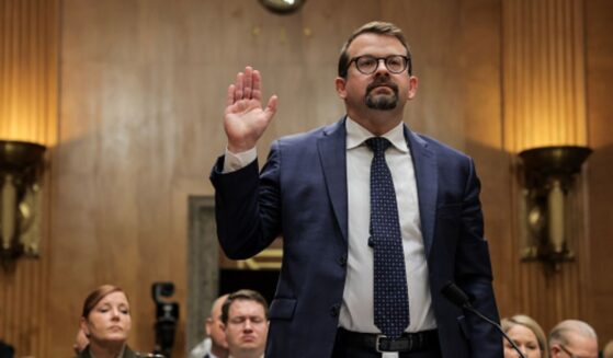 James Erdman III lifts his right hand as he takes the oath to testify to the Senate Homeland Protection and Government Affairs Committee on May 13, 2026.
