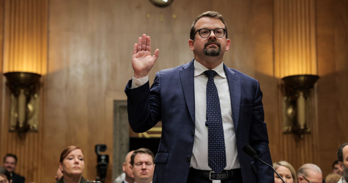 James Erdman III lifts his right hand as he takes the oath to testify to the Senate Homeland Protection and Government Affairs Committee on May 13, 2026.