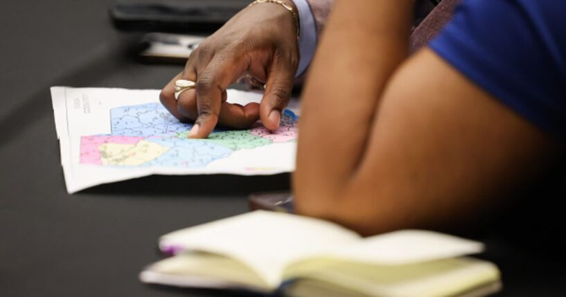 Two women examine the newly redrawn map for South Carolina on May 8, 2026.