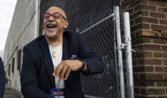 Pennsylvania State Representative Chris Rabb leans over a fence during a campaign event on May 15, 2026.