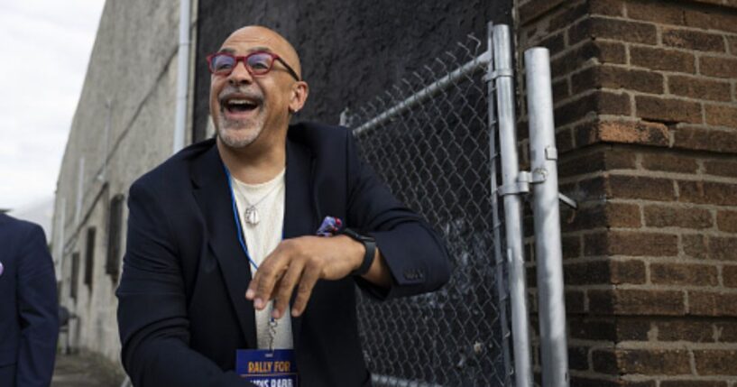 Pennsylvania State Representative Chris Rabb leans over a fence during a campaign event on May 15, 2026.