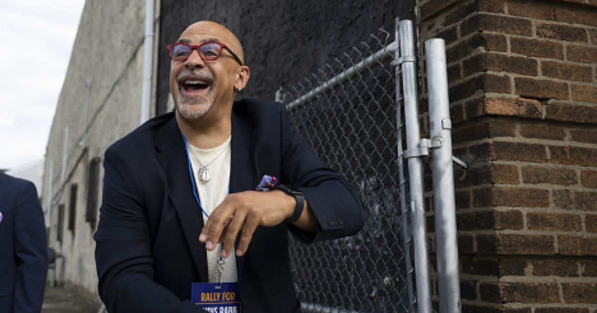 Pennsylvania State Representative Chris Rabb leans over a fence during a campaign event on May 15, 2026.