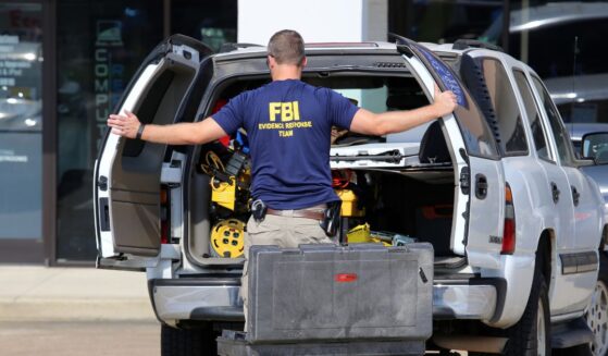 An FBI agent gathers evidence outside the Armed Forces Career Center in Chattanooga, Tennessee, on July 16, 2015.
