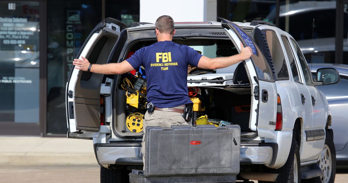 An FBI agent gathers evidence outside the Armed Forces Career Center in Chattanooga, Tennessee, on July 16, 2015.