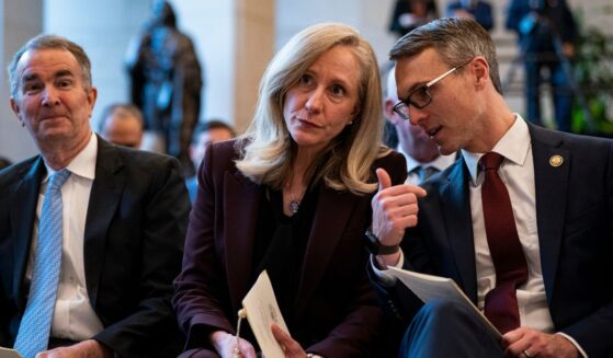 Former Virginia Governor Ralph Northam, then-Governor-elect Abigail Spanberger, and Representative James Walkinshaw sit together at an unveiling ceremony for the statue of a civil rights leader in Emancipatino Hall in the U.S. Capitol Visitors Center in Washington on Dec. 16, 2025.