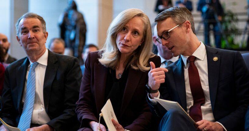 Former Virginia Governor Ralph Northam, then-Governor-elect Abigail Spanberger, and Representative James Walkinshaw sit together at an unveiling ceremony for the statue of a civil rights leader in Emancipatino Hall in the U.S. Capitol Visitors Center in Washington on Dec. 16, 2025.