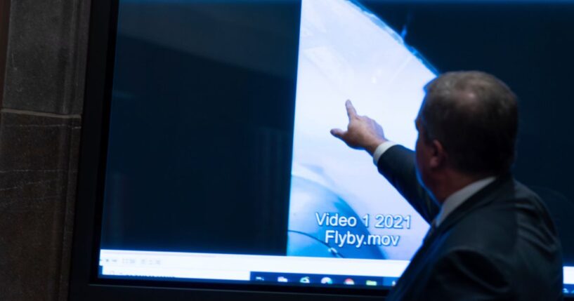 Then Deputy Director of Naval Intelligence Scott Bray points to a video display showing an Unidentified Anomalous Phenomena (UAP) during a hearing of the House Intelligence, Counterterrorism, Counterintelligece, and Counterproliferation Subcommittee hearing on Capitol Hill in Washington on May 17, 2022.