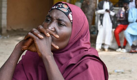 A family member of a victim of the Islamist terror group Boko Haram clasps her hands together in Babban Gide on Sept. 4, 2024.