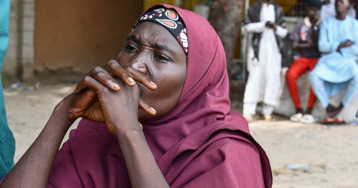 A family member of a victim of the Islamist terror group Boko Haram clasps her hands together in Babban Gide on Sept. 4, 2024.