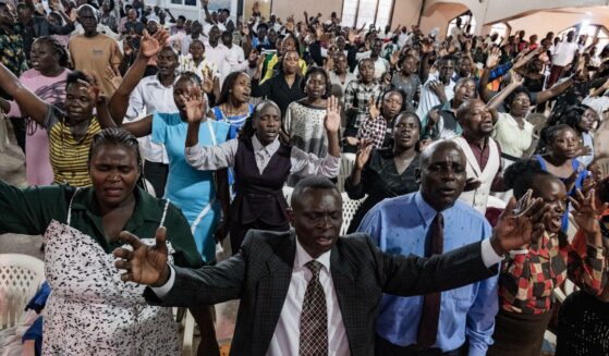 Christians raise their hands in worship at a church in Kampala, Uganda on Jan. 11, 2026.