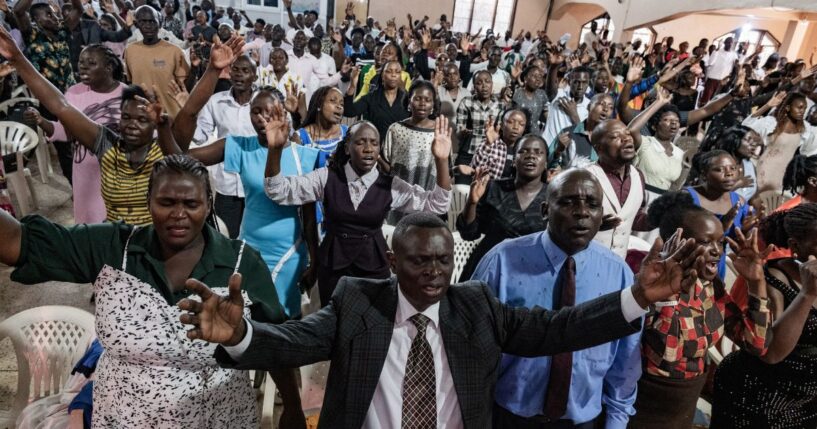 Christians raise their hands in worship at a church in Kampala, Uganda on Jan. 11, 2026.