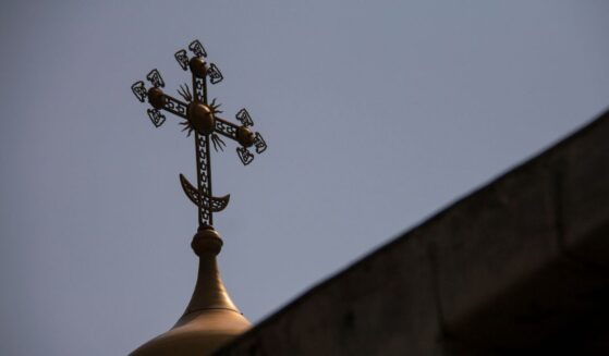 A cross sits on top of the Dulab Mausoleum in Tehran.