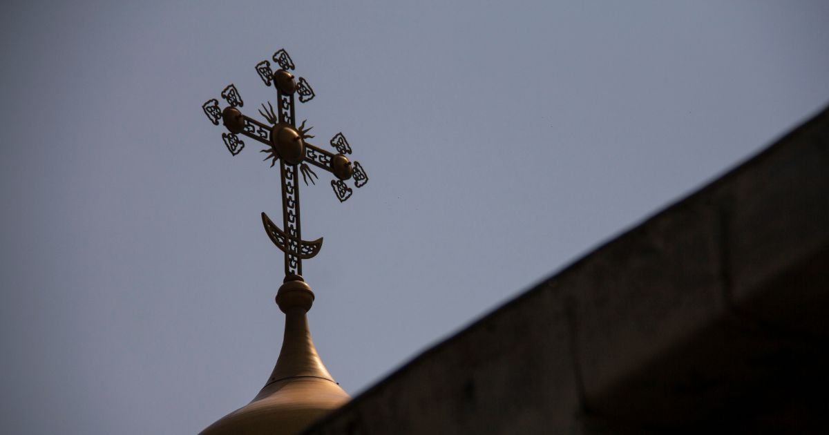 A cross sits on top of the Dulab Mausoleum in Tehran.