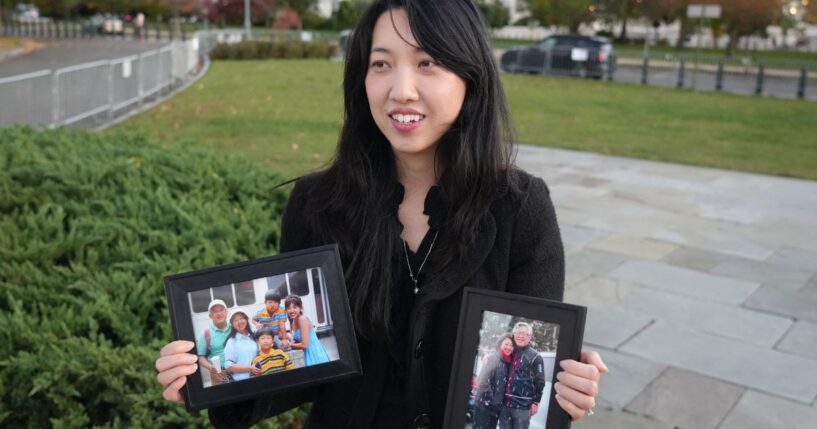 Grace Jin Drexel, the daughter of detained Chinese pastor Jin Mingri, holds up framed photos of Mingri and his family in Washington, DC on Oct. 30, 2025.