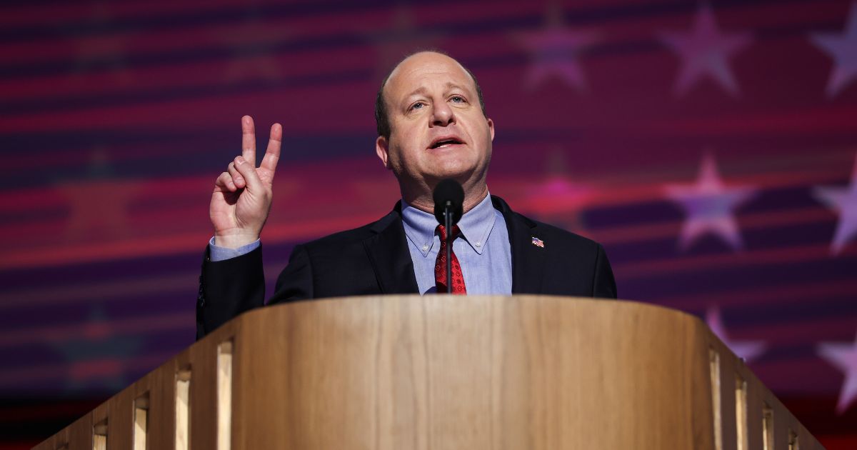 Colorado Governor Jared Polis speaks on stage at the Democratic National Convention in Chicago on Aug. 21, 2024.