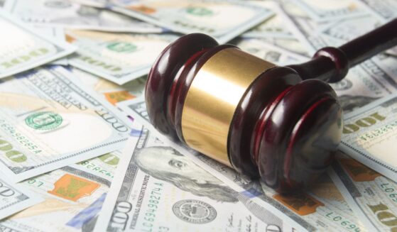 A gavel sits on a pile of cash.
