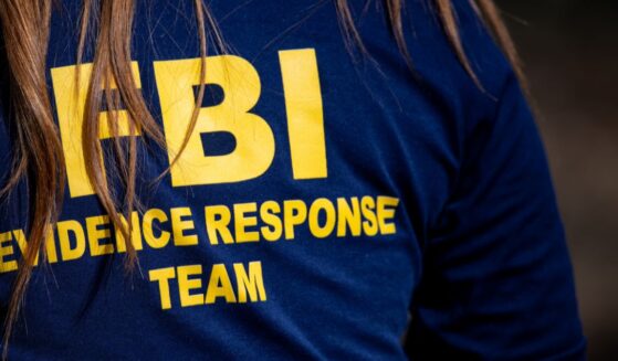 A member of the FBI surveils a crime scene in Tucson, Arizona, on Feb. 11, 2026.