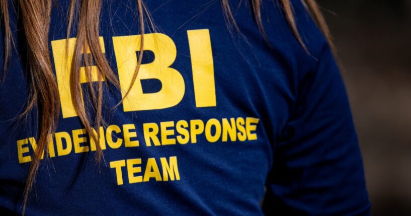 A member of the FBI surveils a crime scene in Tucson, Arizona, on Feb. 11, 2026.