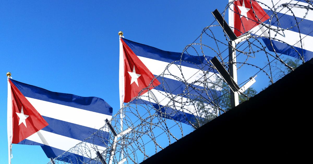 The Cuban flag flies above the walls of a prison.