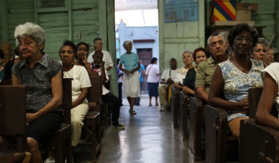 Parishioners sit and listen during a Catholic Church service in a poor suburb in Santiago de Cuba, Cuba on March 24, 2012.