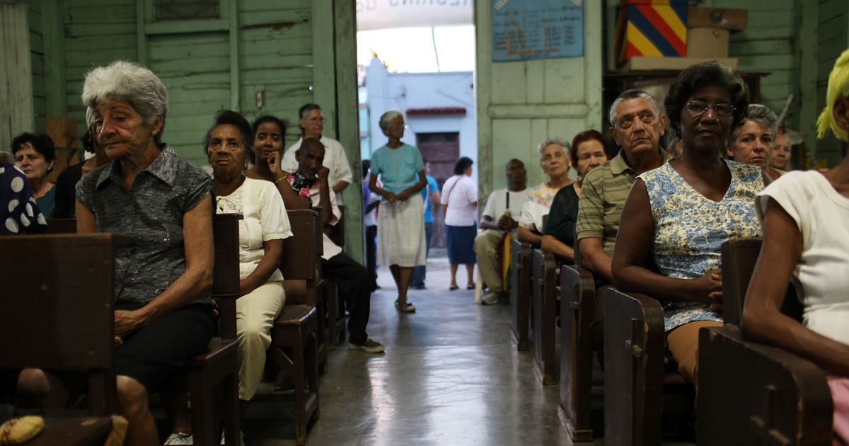 Parishioners sit and listen during a Catholic Church service in a poor suburb in Santiago de Cuba, Cuba on March 24, 2012.