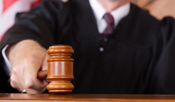 A close-up image of a judge holding a gavel.