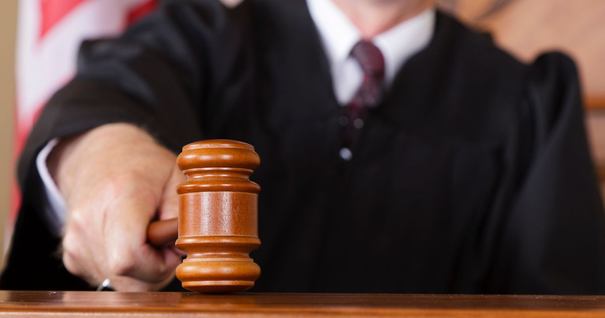 A close-up image of a judge holding a gavel.