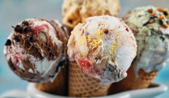 A variety of ice cream flavors in cones.