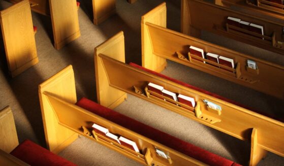 Church pews inside a sanctuary.
