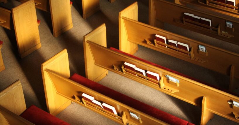 Church pews inside a sanctuary.