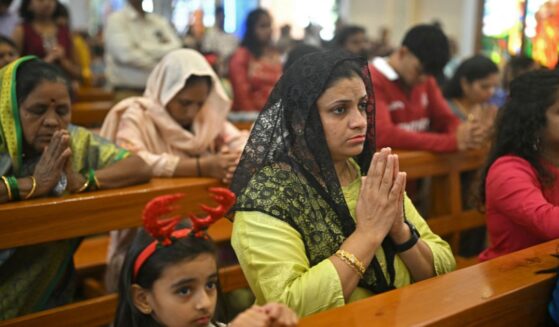Christians kneel in the pews of a church and pray in Bengaluru on Dec. 25, 2025.