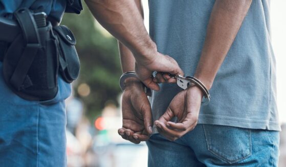 A police officer handcuffs a suspect.