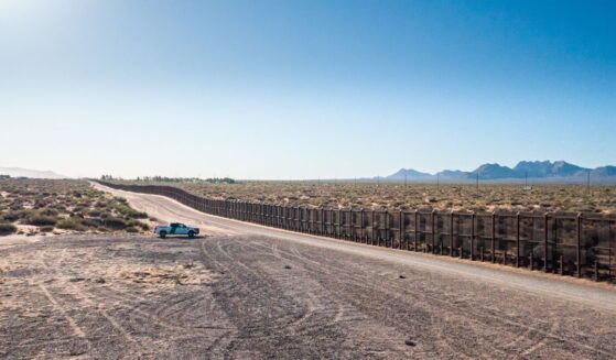 A border patrol vehicle stands parked near the U.S.-Mexico border on a sunny day in El Paso, Texas.