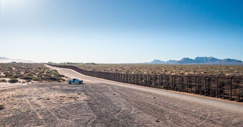 A border patrol vehicle stands parked near the U.S.-Mexico border on a sunny day in El Paso, Texas.
