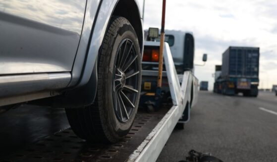 A car is loaded onto a tow truck.