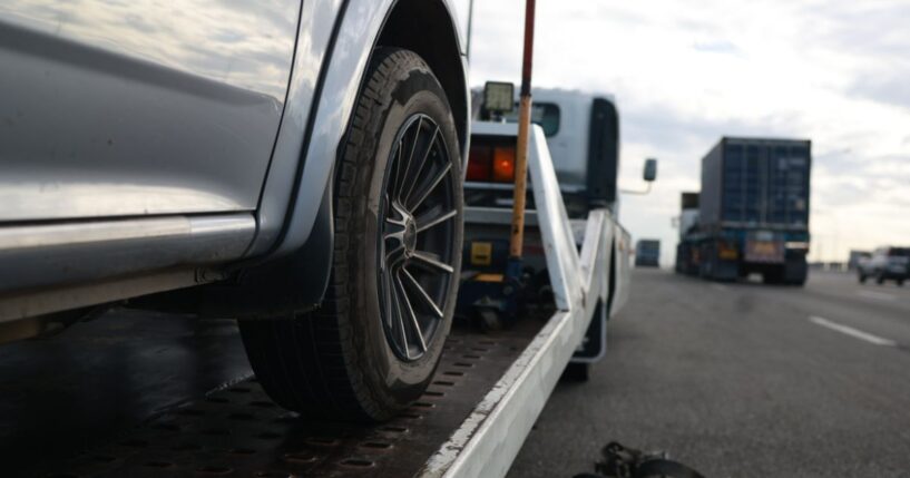 A car is loaded onto a tow truck.