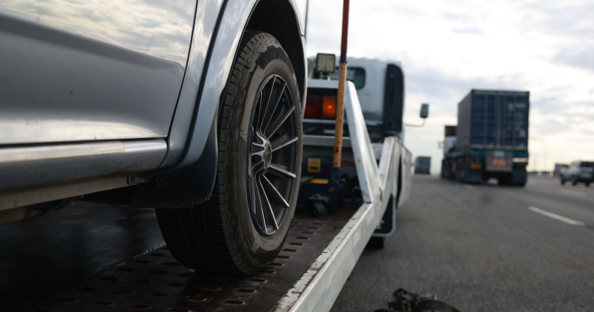 A car is loaded onto a tow truck.