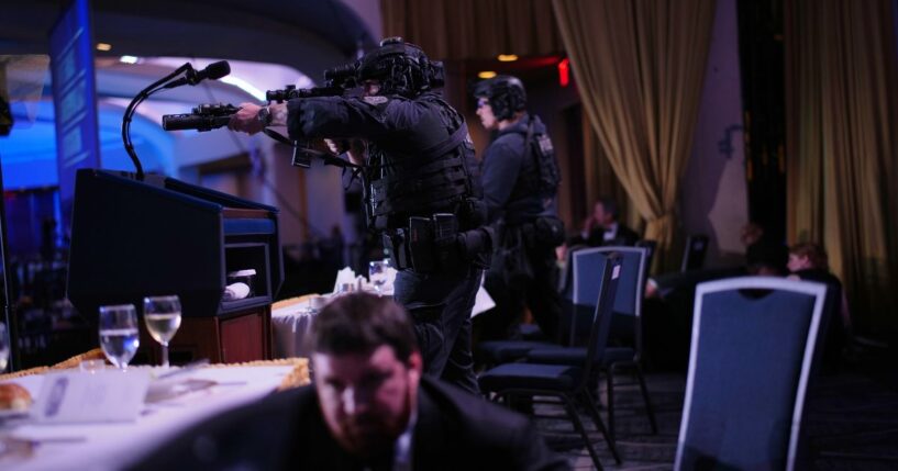 Agents stand guard after a shooting took place at the White House Correspondents' dinner at the Washington Hilton in Washington, DC on April 25, 2026.