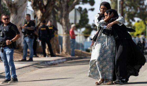 Two women react as they leave a reunification center following the shooting at the Islamic Center of San Diego in southern California Monday.